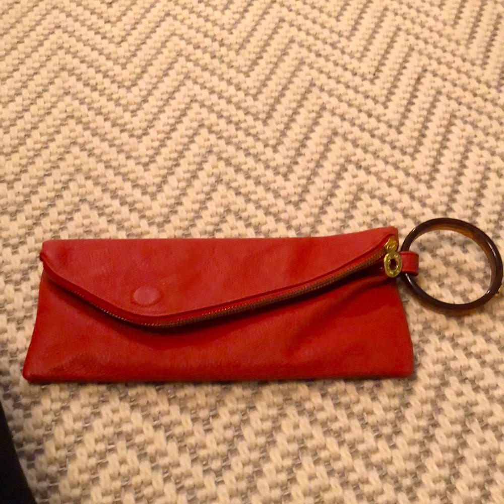 Orange leather wristlet/clutch by Mud Pie.